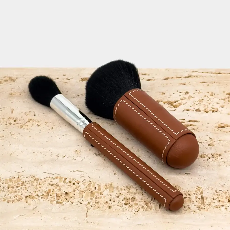 Refined Vèlle Milano cleaning brushes with brown leather handles, white stitching, black bristles and silver metal ferrule