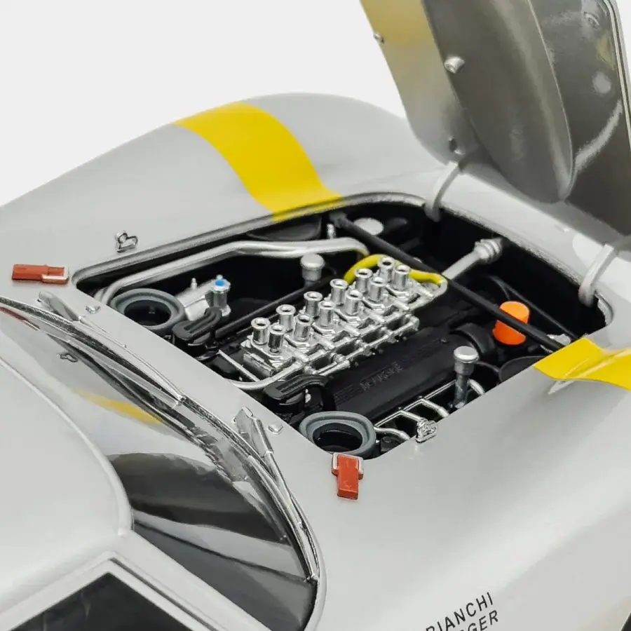 Sleek Vèlle Milano Ferrari 250GTO Tour de France model in glossy silver metal with Modena yellow racing stripe on marble base