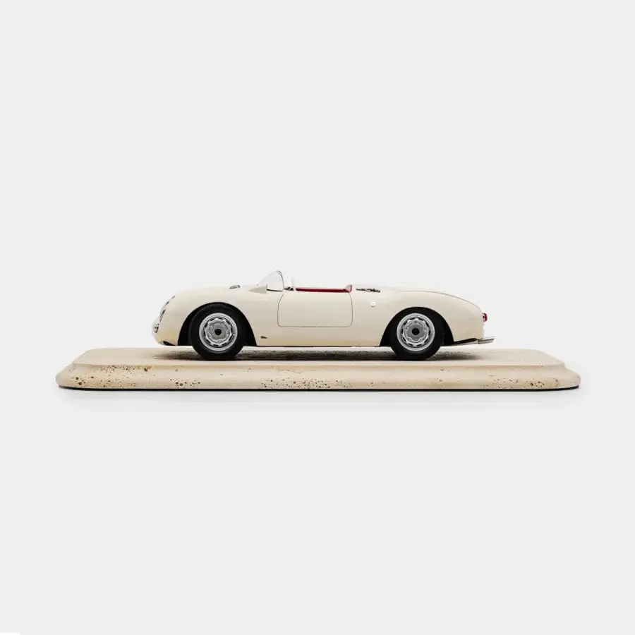 Sophisticated Vèlle Milano Porsche 550A Spyder model in glossy off-white metal with red interior and natural marble base