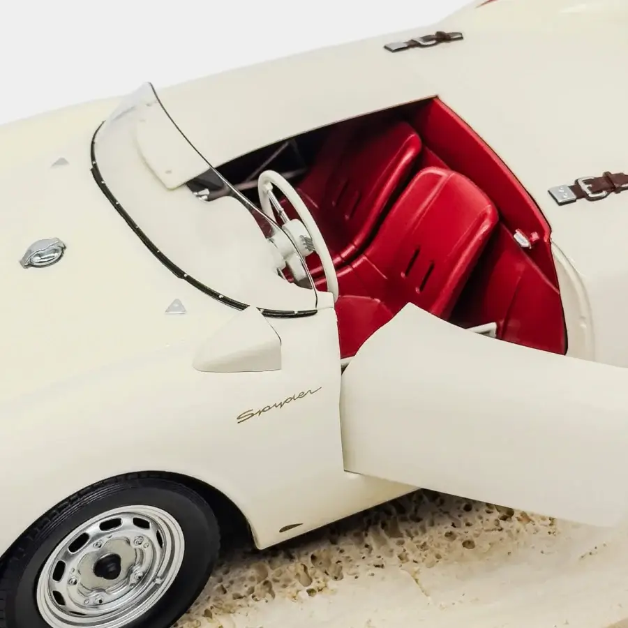 Meticulous Vèlle Milano Porsche 550A Spyder model in glossy white metal with vibrant red interior and natural marble base