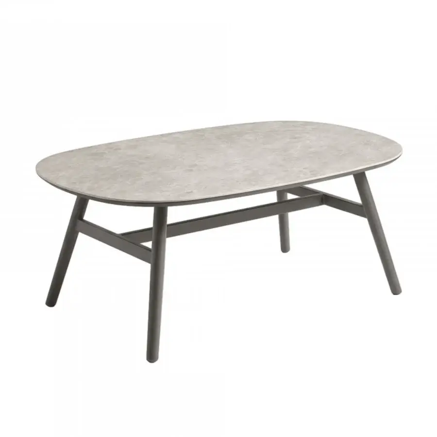 Pristine Roberti Rattan Altomare coffee table with low-profile light grey stone surface and graphite aluminum base