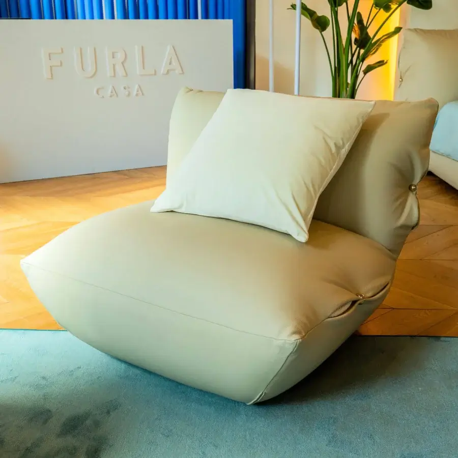 Sophisticated Furla Casa Cherry Blossom lounge chair in creamy beige leather with satin finish and organic silhouette
