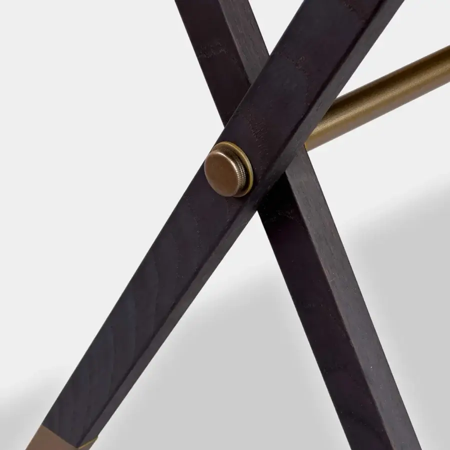 Architectural Vèlle Milano Aliseo side table with X-frame structure in dark matte solid wood and brushed brass detailing
