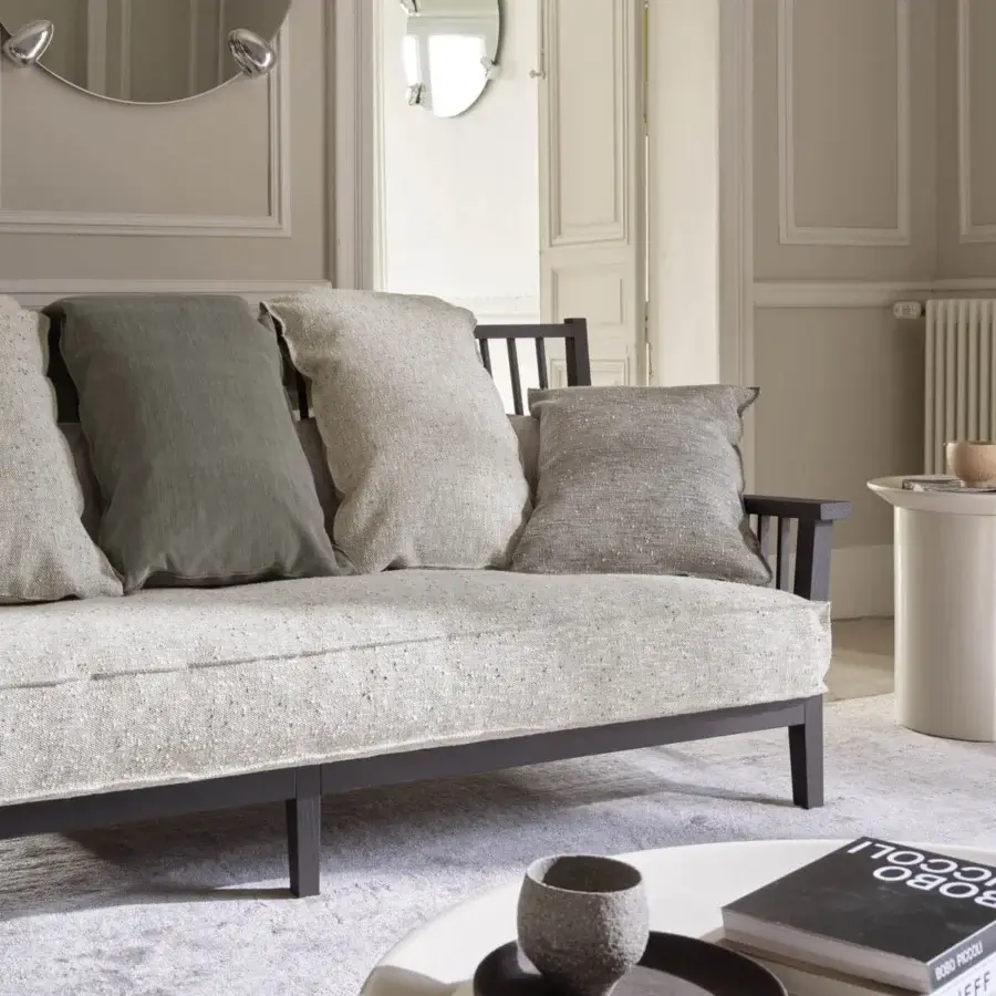 Sophisticated Gervasoni sofa with voluminous textured light gray-beige textile and matte dark finish ash wood frame