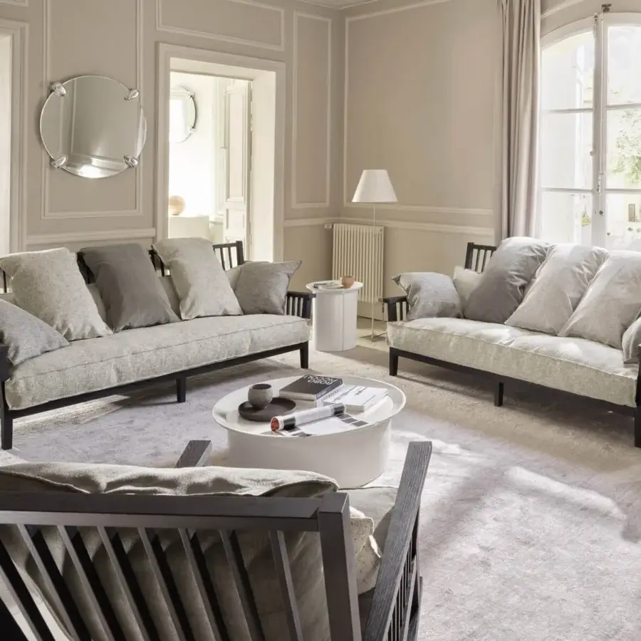 Harmonious Gervasoni Gray 03 sofa with light textured textile cushions and architectural dark finish ash wood frame