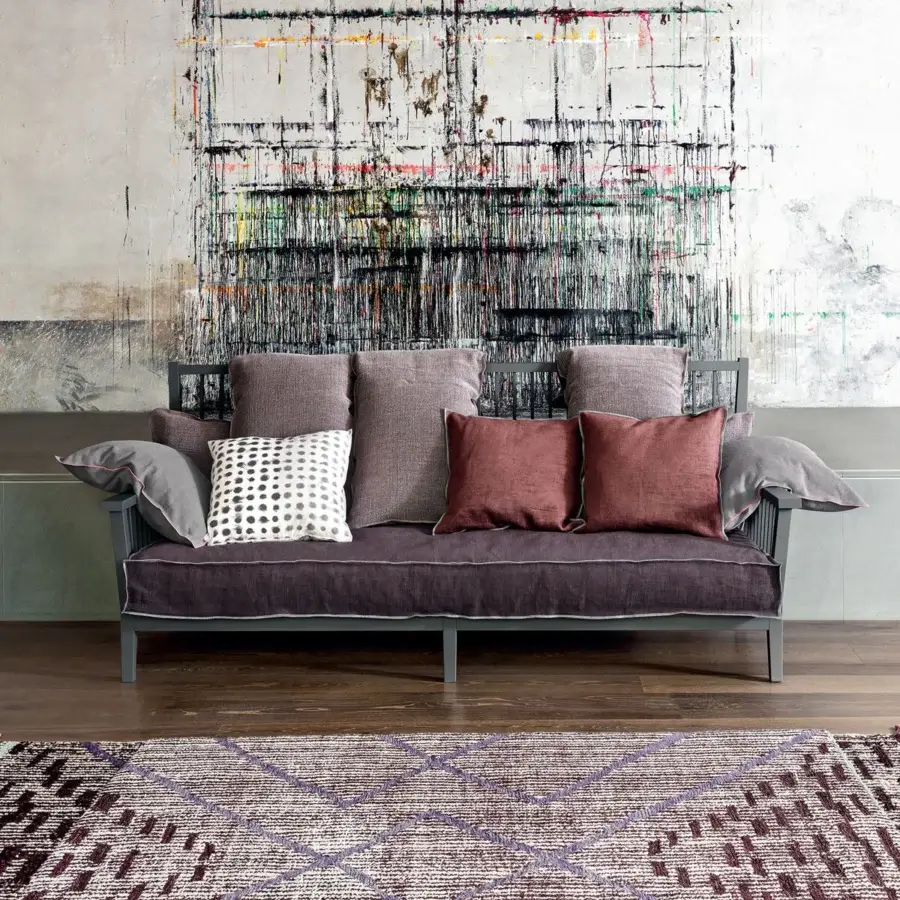 Sumptuous Gervasoni Gray 03 sofa with deep purple mauve terracotta cushions and matte dark ash wood frame