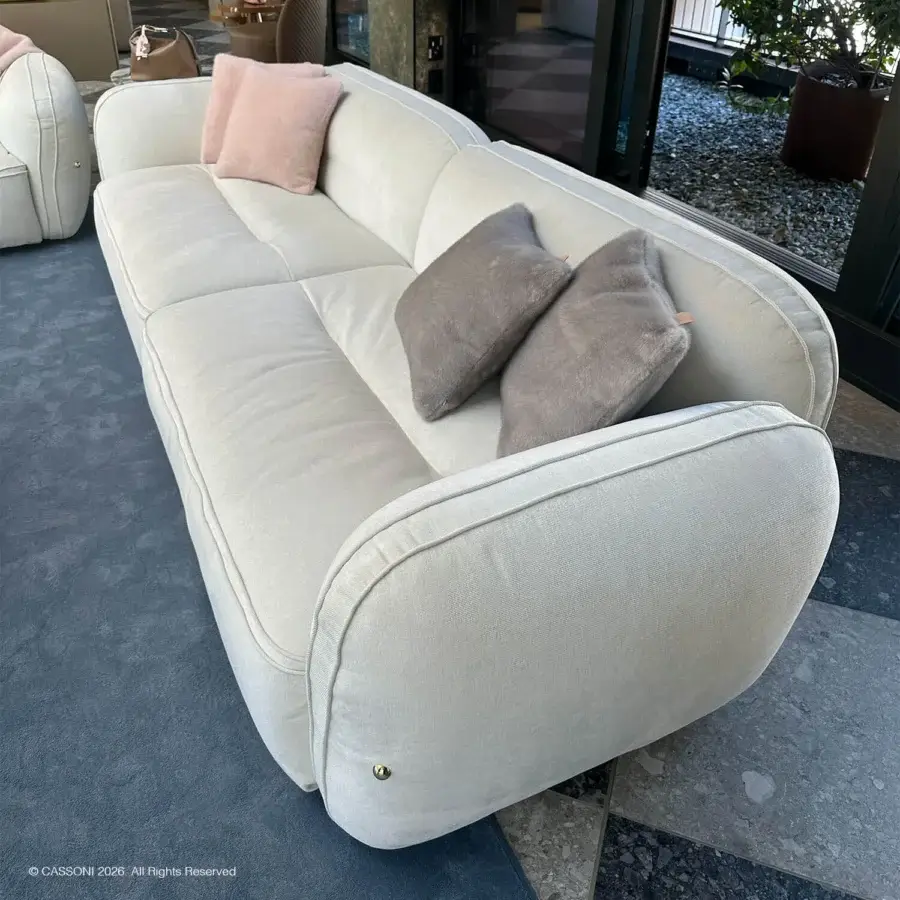 Exquisite Furla Casa Moonstone sofa in light cream fabric with organic rounded lines and black finished beech wood feet