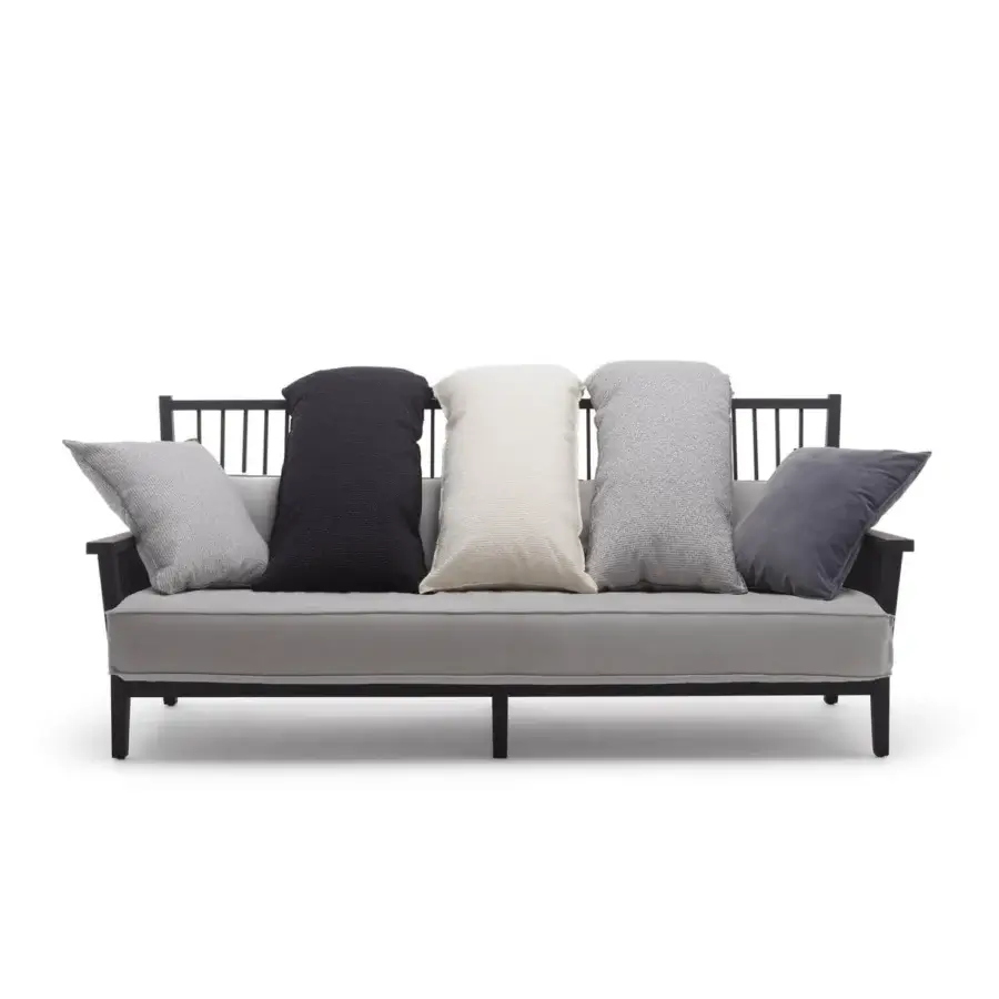 Sleek Gervasoni Gray 03 sofa in matte black ash wood with a linear slatted backrest and cream down cushions