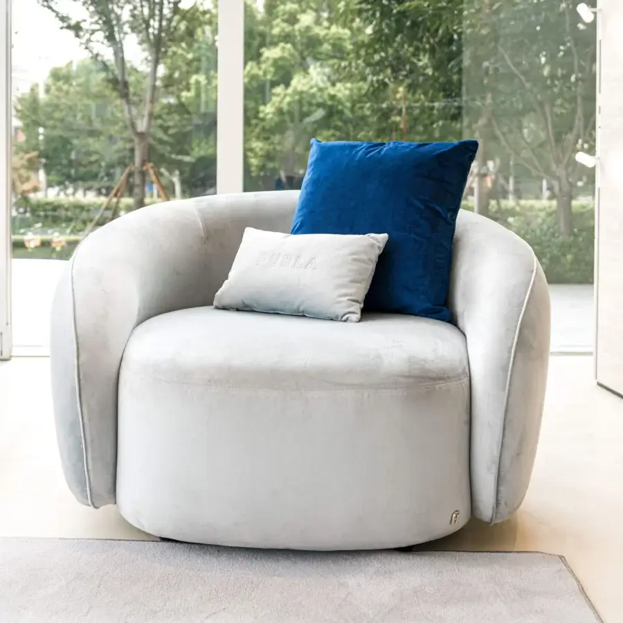 Graceful Furla Casa Opportunity lounge chair with organic rounded silhouette in light grey textile and black beech base