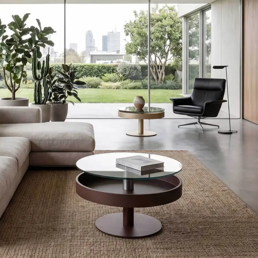 Architectural Naos Levante round coffee table with clear glass top and matte dark brown painted wooden drawer frame