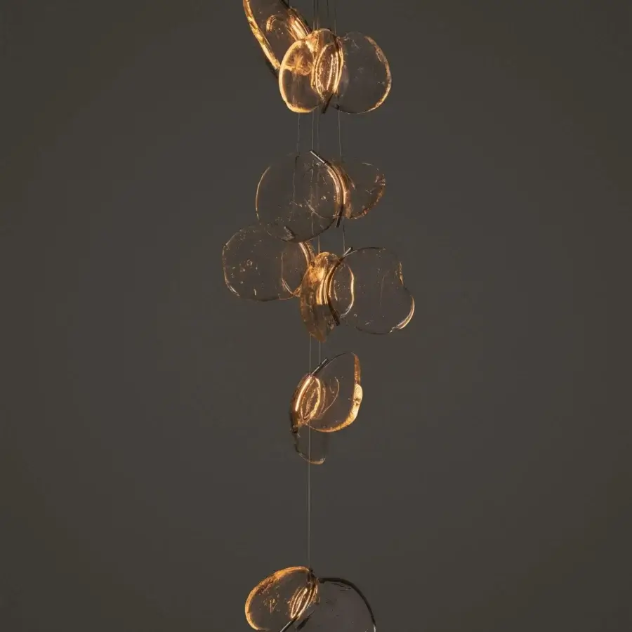 Captivating Bocci 141 cluster suspension lamp in clear sculptural translucent glass with thin metal cables and golden amber glow