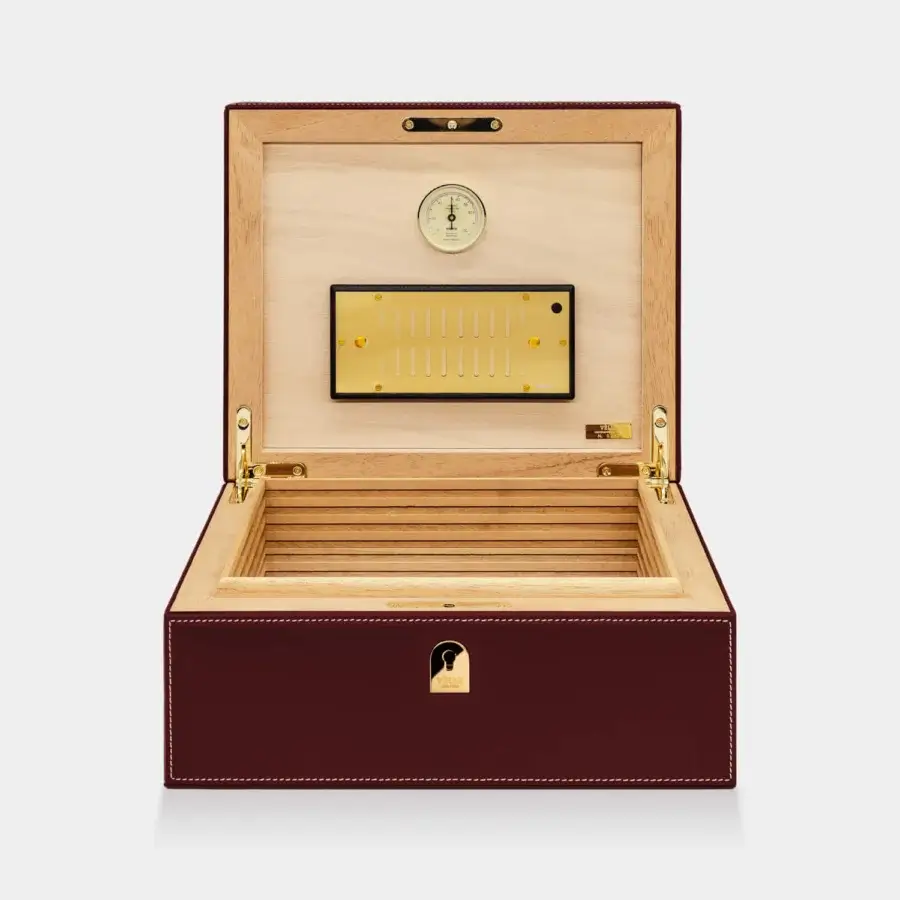 Sumptuous Vèlle Milano Cigars Humidor in burgundy padded leather with white stitching and polished gold-toned hardware