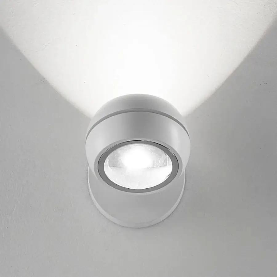 Elegant Lodes Nautilus Mini wall lamp with curved lines in matte white metal for dynamic illumination