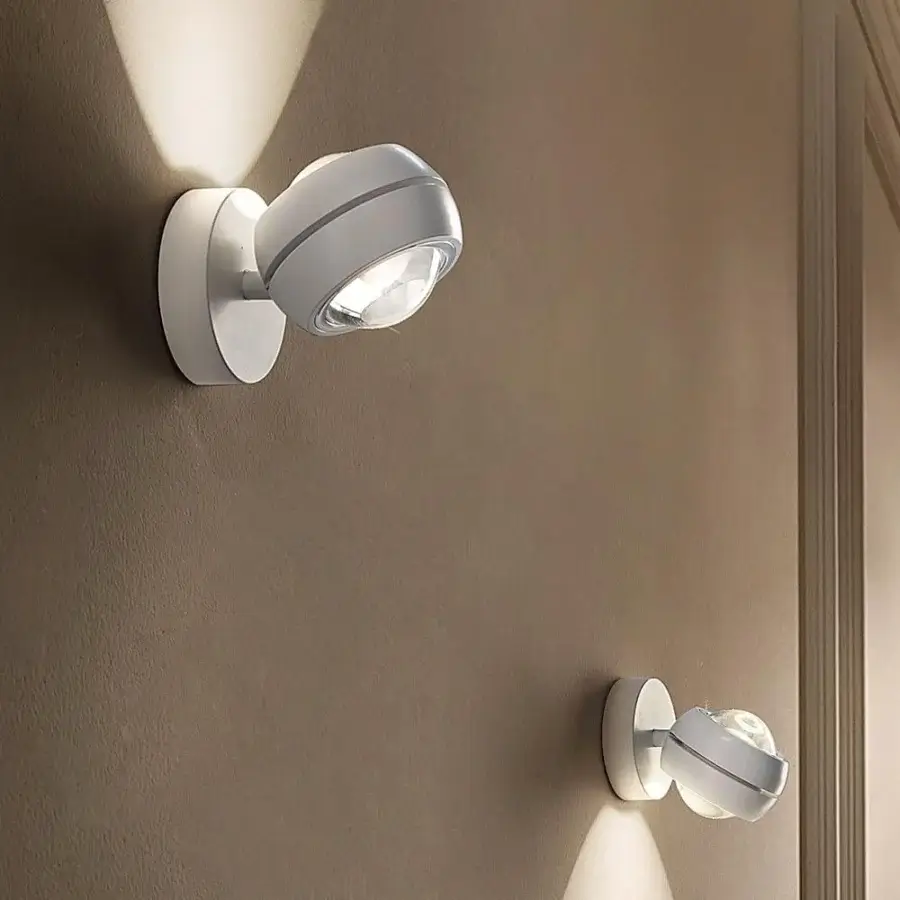 Captivating Lodes Nautilus Mini wall lamp with a spherical form in white metal and a subtle dark grey band with matte finish