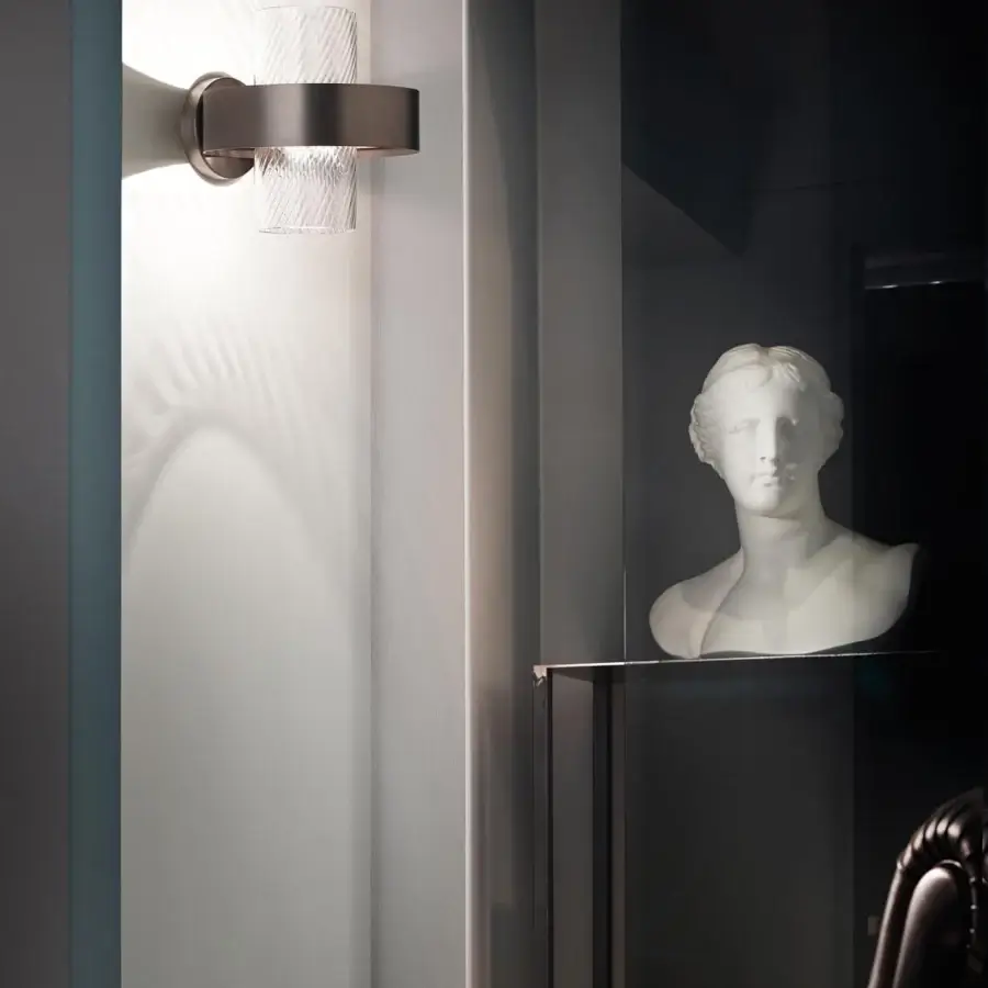 Elegant Vistosi Armonia wall lamp with a metal ring and textured glass cylinder diffusers in crystal and smoke tones with a matte finish