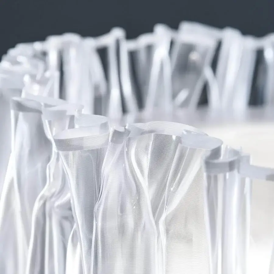 Distinguished Slamp Accordeon table lamp with a vertically-ribbed white Lentiflex® shade creating a captivating translucent silhouette