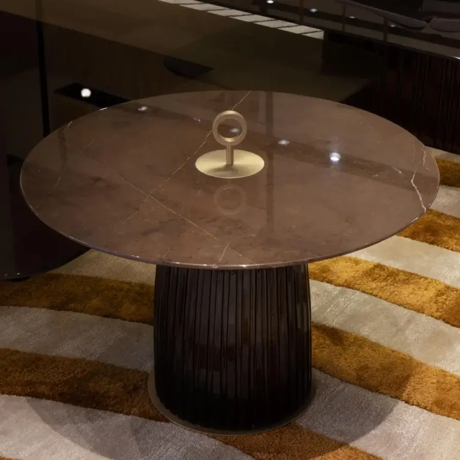 Sophisticated Paolo Castelli Dione side table with reflective marble top and dark ceramic base showing vertical ribbing