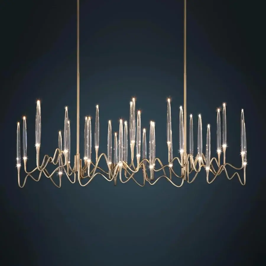 Distinguished Il Pezzo 3 Long Chandelier crafted in hand-forged gold tone brass with clear solid crystal diffusers creating romantic light