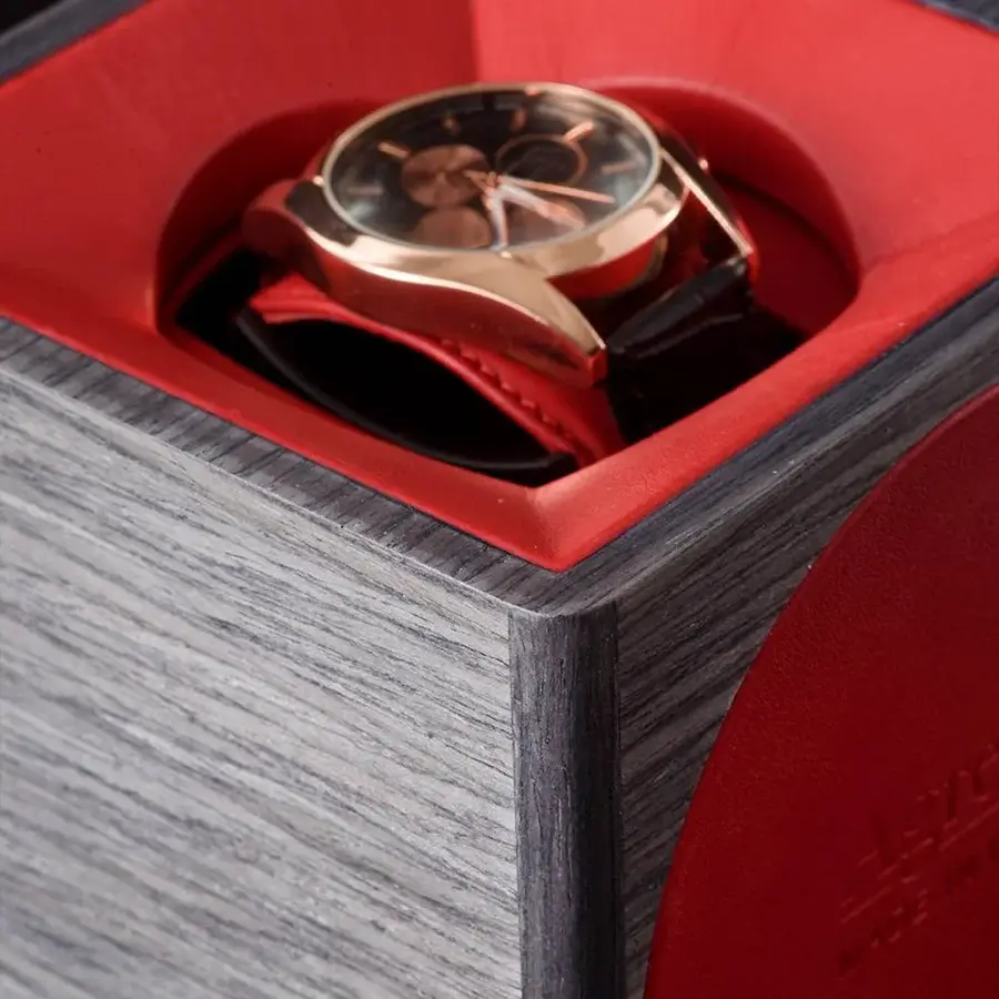 Luxury Agresti Tempo Unico watch winder with textured grayish wooden exterior grain patterns and vibrant red lining interior
