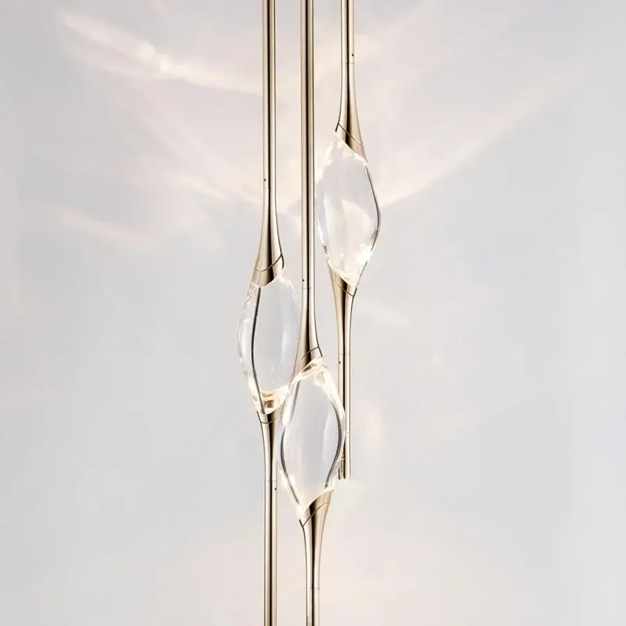 Elegant Il Pezzo Mancante lamp crafted in clear crystal with glossy gold stems offering diffused ambient light and a unique identity stamp