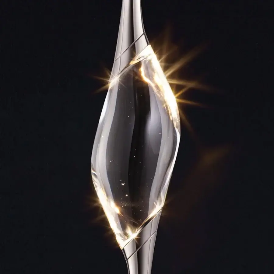 Exclusive Il Pezzo 12 suspension lamp with a clear crystal droplet and glossy brass casting rings emitting a warm glow
