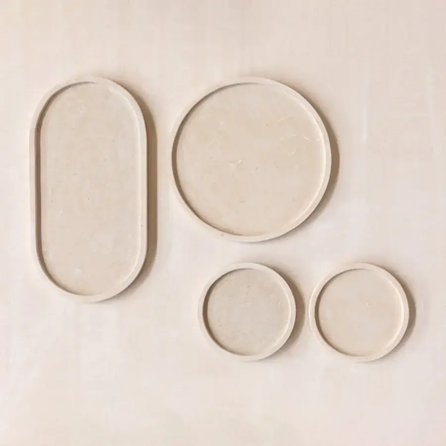 Exquisite PIMAR Messapo trays set in pale beige natural stone with matte porous finish