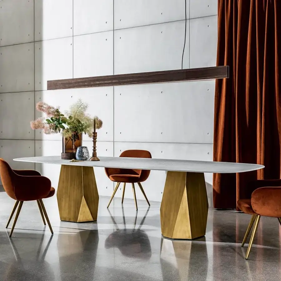 Distinguished Sovet Italia Deod table with a light gray ceramic laminated oval top and golden lacquered geometric metal bases