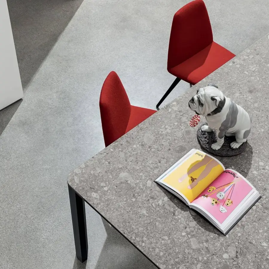 Distinguished Sovet Italia Kodo table with speckled gray ceramic and sleek matte black aluminum structure