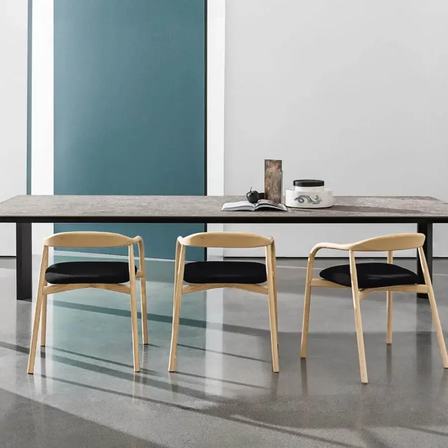 Superior Sovet Italia Kodo table with mottled gray ceramic top and dark-toned aluminum legs crafted in a minimalist finish