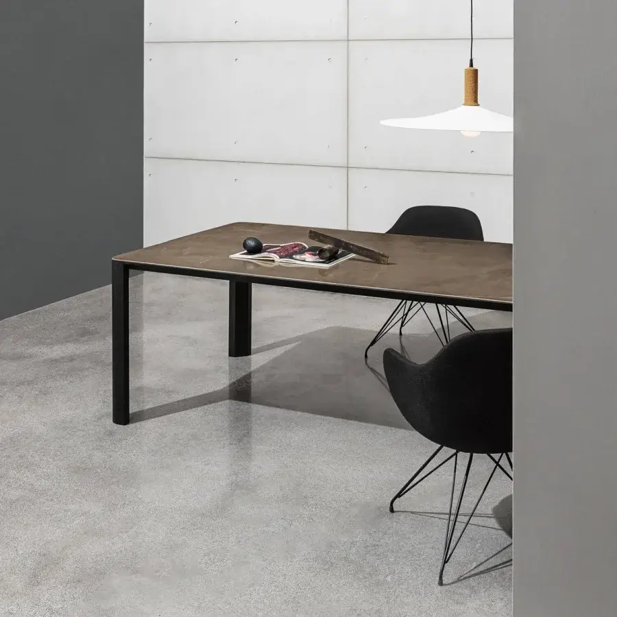Elegant Sovet Italia Kodo table with refined black aluminum structure and rich brown stone-like ceramic top