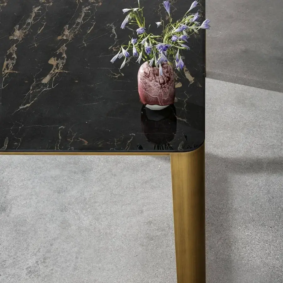 Distinguished Sovet Italia Kodo table with glossy black ceramic top and brushed gold aluminum legs showcasing gold veining