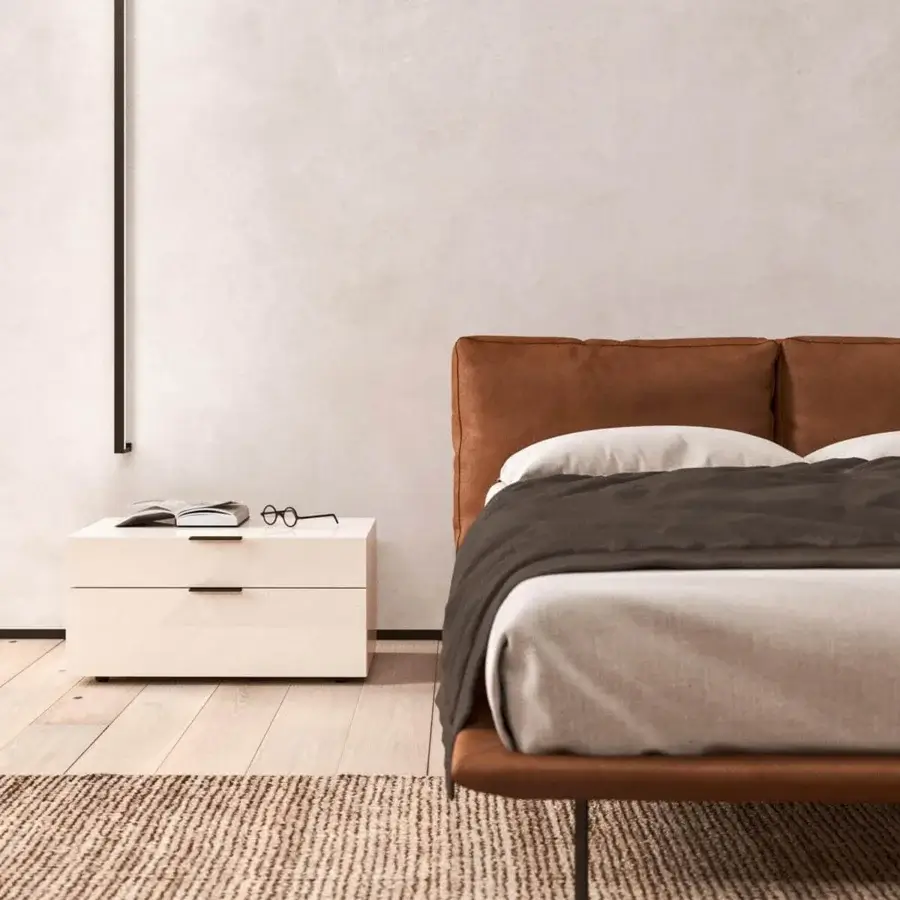 Exceptional Presotto Cali bed with smooth brown leather upholstery and slim dark metal feet crafted with a refined headboard