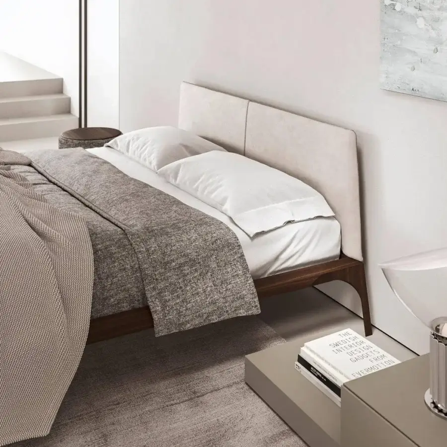 Elegant Presotto Relevè bed with light beige textile and dark brown wood veneer, showcasing dynamic lines