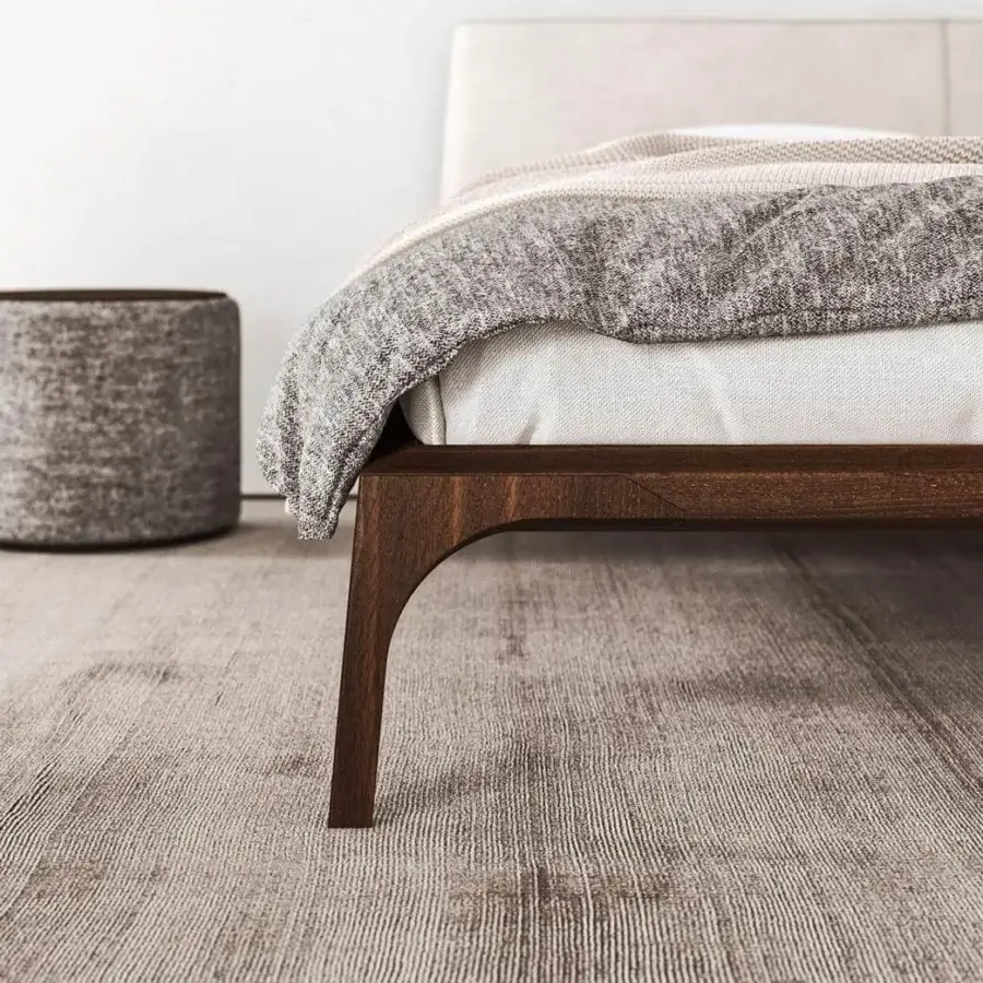 Captivating Presotto Relevé bed with a light textile headboard and dark stained wood veneer structure built with curved legs