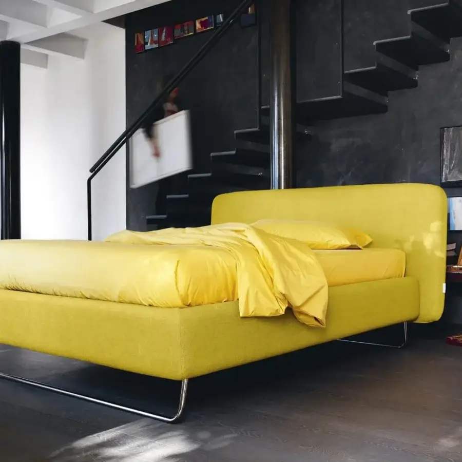 Elegant Noctis Doxy Wide bed in vibrant chartreuse textile with rounded headboard plus polished metal sled leg supports
