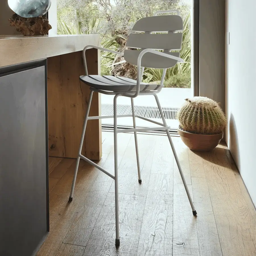 Sophisticated Slide Ribs Up stool with tubular metal frame and slatted seat in light gray matte finish