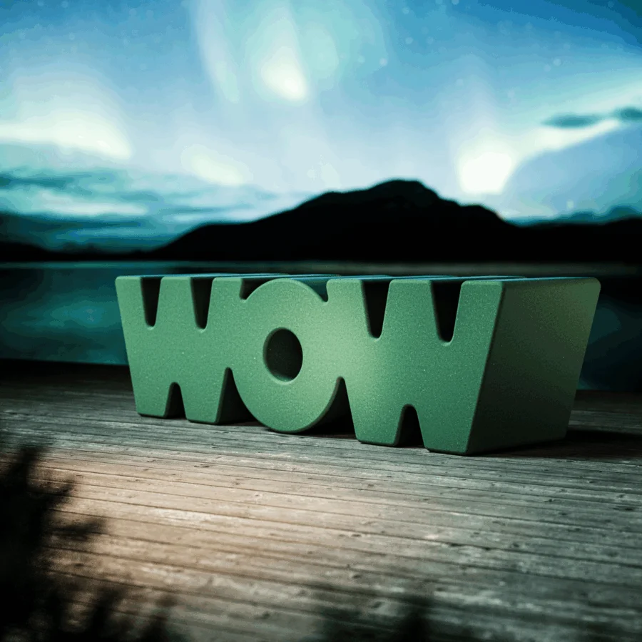Luxury Slide Wow bench in medium green polyethylene with a matte finish and an innovative monolithic typographic form