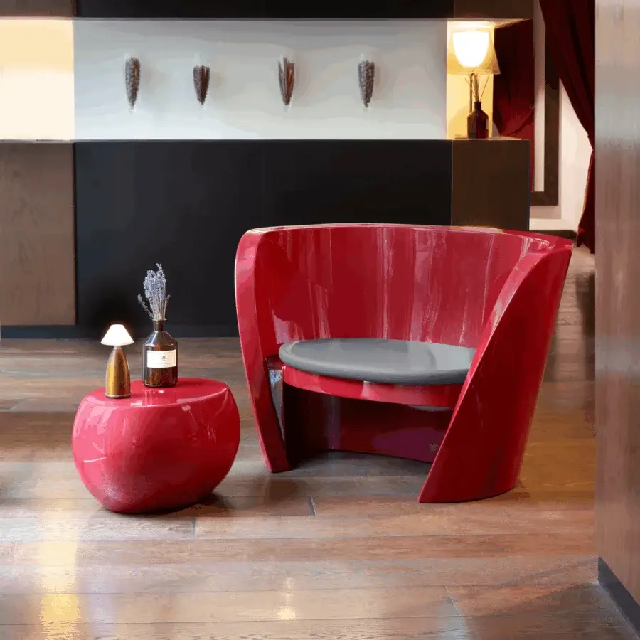 Elegant Slide Rap lounge chair in glossy red polyethylene with fluid sculptural silhouette and soft grey textile cushion