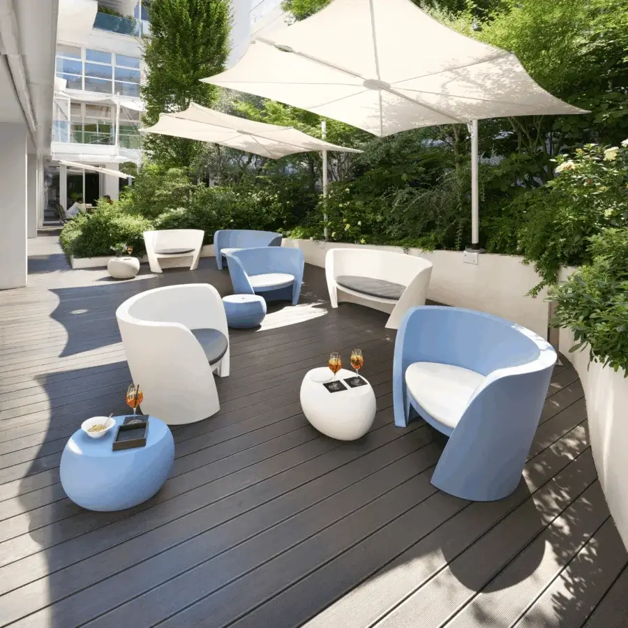 Luxury Slide Rap lounge chair in white polyethylene with smooth matte finish and contrasting dark cushions wraparound