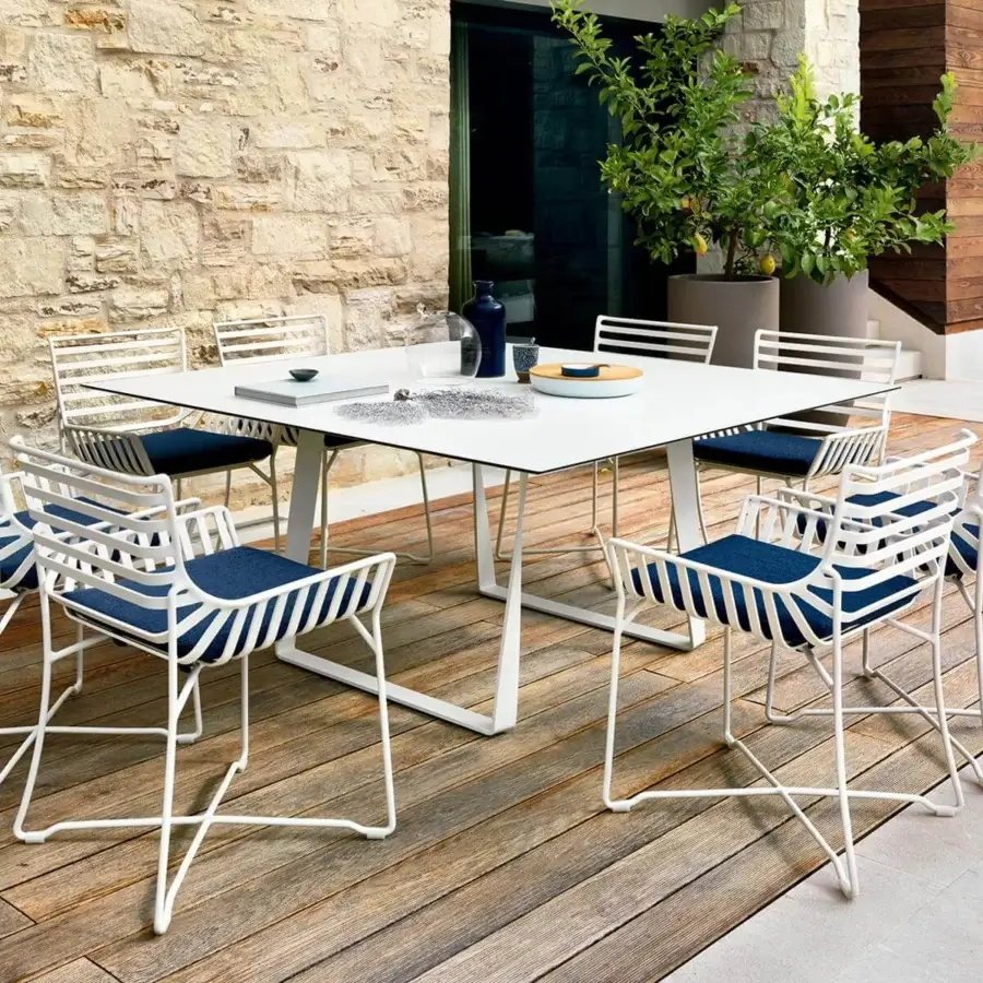 Superior Roberti Rattan Hamptons Graphics table with white HPL tabletop and powder-coated metal cross base in a matte finish