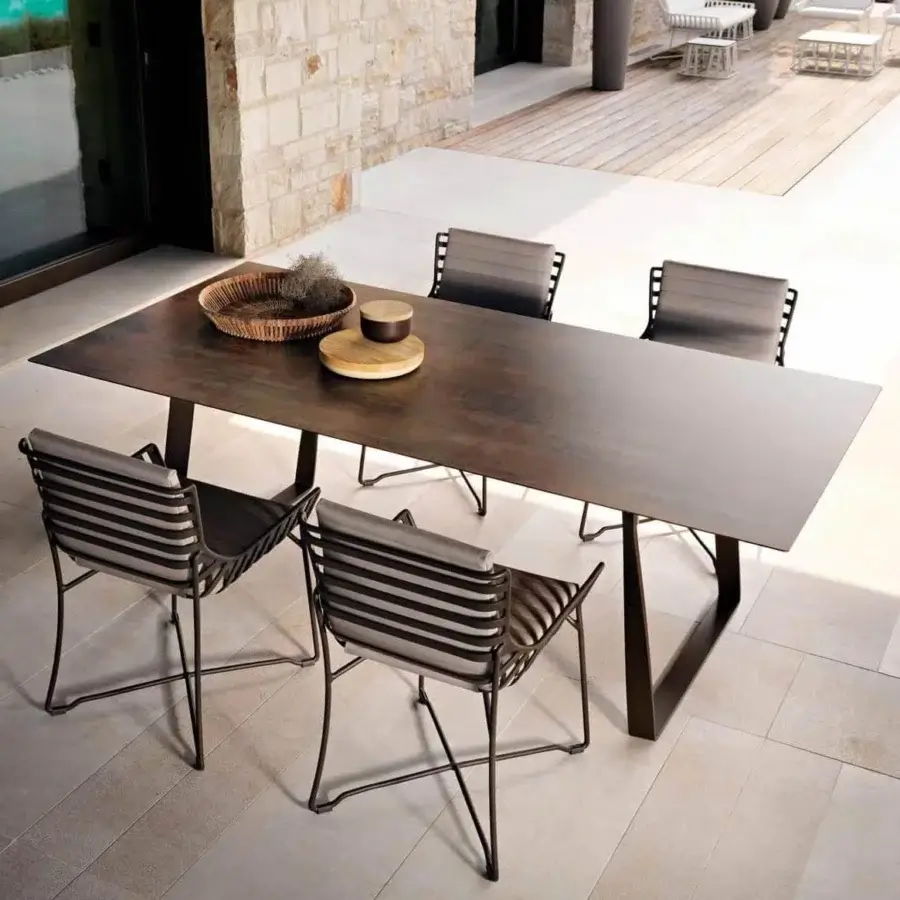 Refined Roberti Rattan Hamptons Graphics table with a durable square HPL top and warm bronze powder-coated metal base in a matte finish