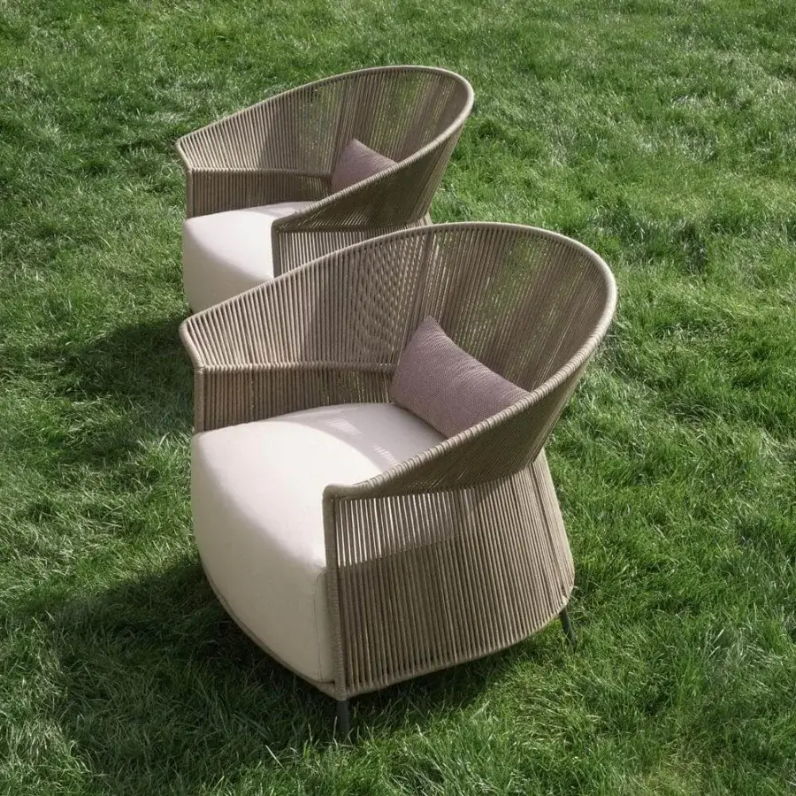 Stylish Potocco Ola lounge chair with hand-woven tan “Fly” ribbon frame and dark, slender legs