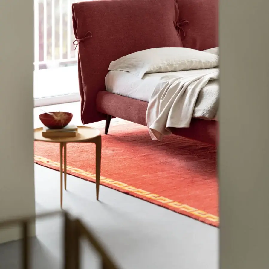 Sophisticated Noctis double bed with terracotta fabric padded headboard and dark metal legs