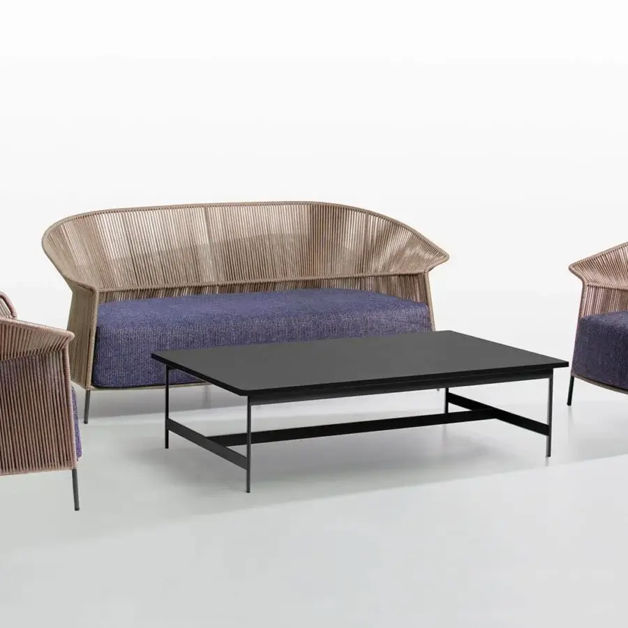 Sophisticated Potocco Ola sofa with a handwoven “Fly” ribbon backrest and textured dark blue patterned outdoor fabric cushions