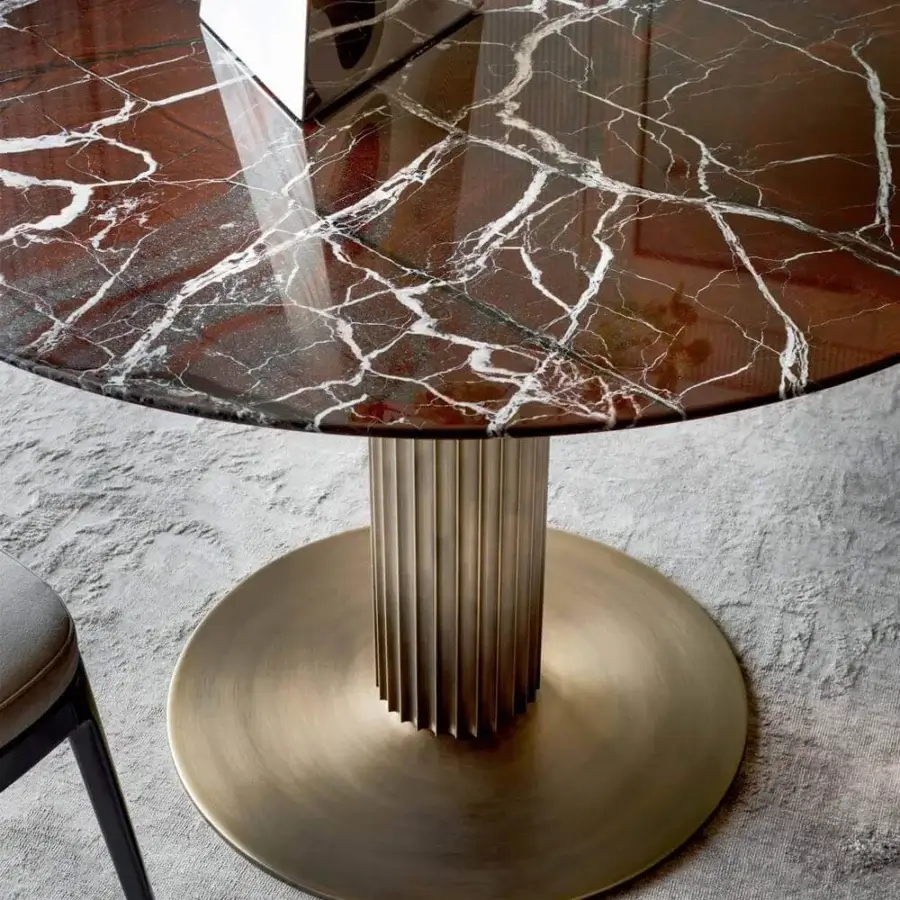 Captivating Rugiano Liberty table with a swirling white-veined marble top and vertically ridged bronze-finished aluminum base