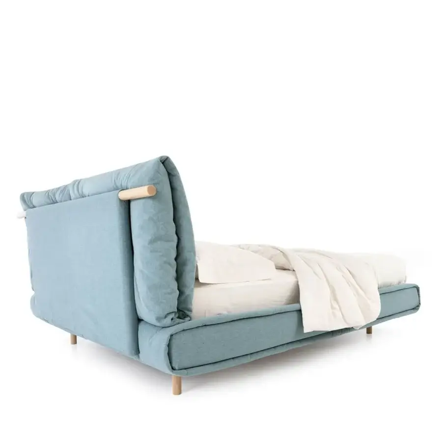 Sophisticated Noctis Mio bed in muted teal textile and smooth light natural wood finish with soft lines