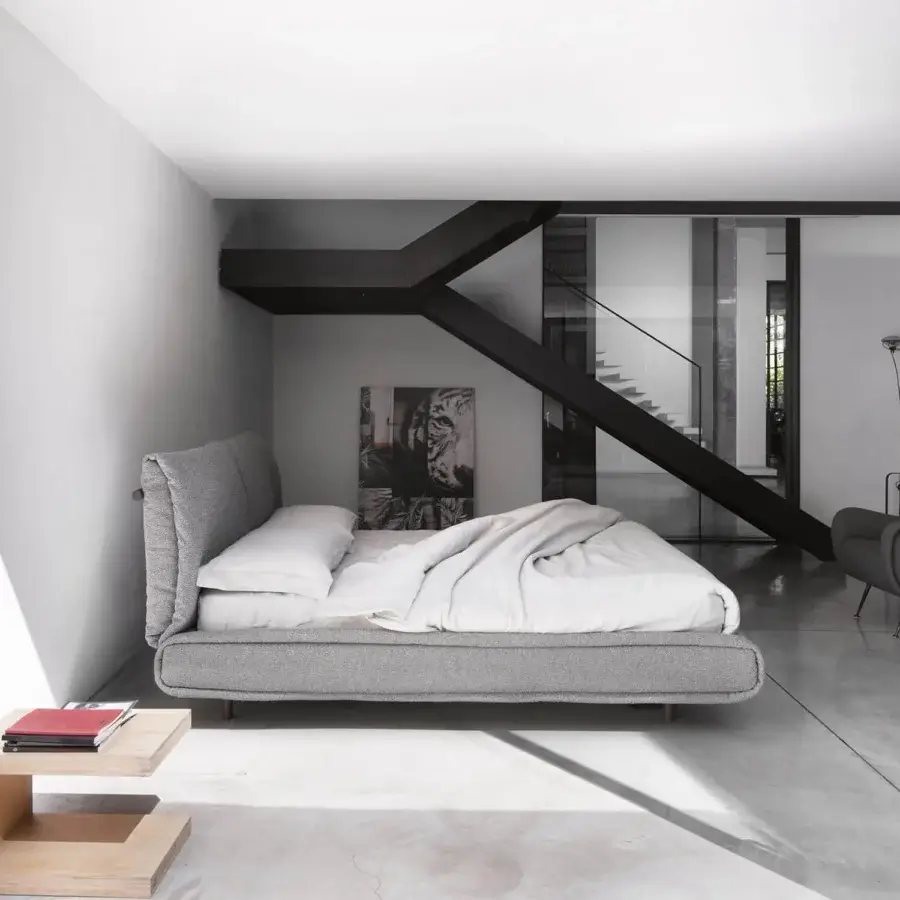 Luxury Mio bed by Noctis with plush neutral grey textile upholstery and a matte textured solid wood frame in Italy
