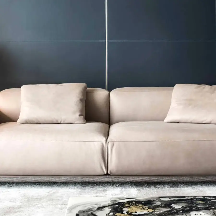 Refined Rugiano Boheme sofa with light beige leather upholstery and woven leather base with gold-toned metal details and matte finish