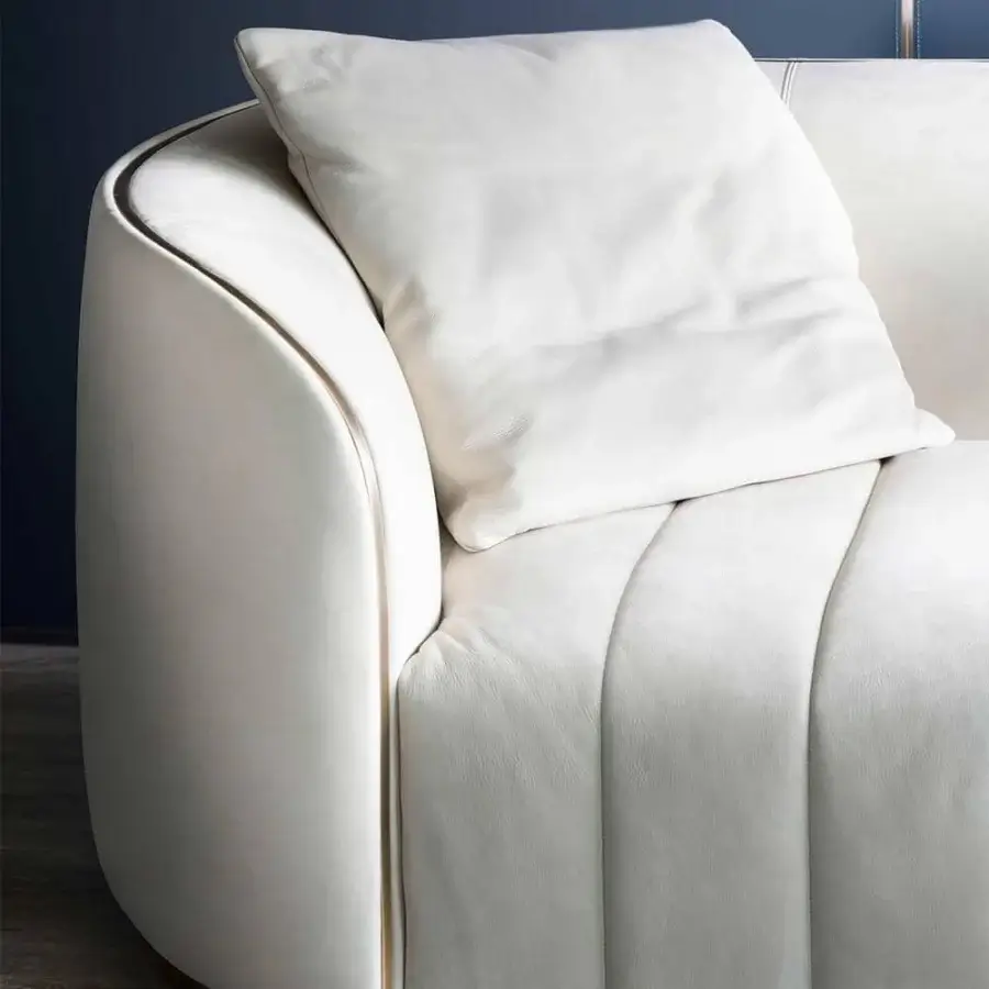 Elegant Rugiano Pierre sofa with channeled sections, bronze metal base and trim in smooth off-white fabric or leather upholstery