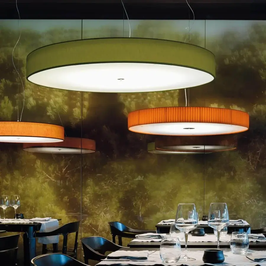 Elegant Modo Luce Discovolante suspension lamp with a textured fabric exterior in vibrant green and white illumination